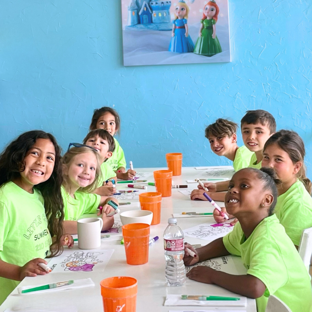 Class of students painting pottery in the best Houston pottery studio